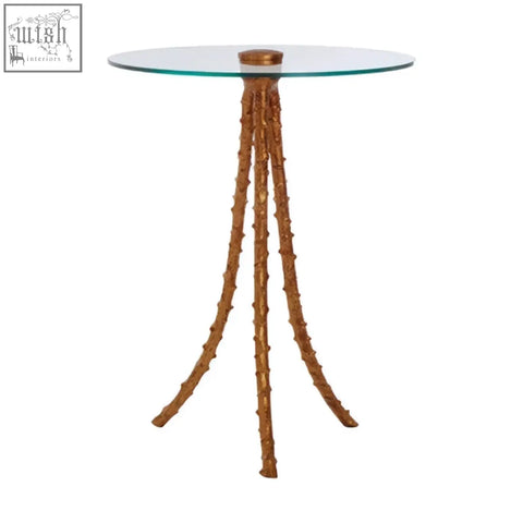 Sika large side table with a warm gold triple-leg base and a sleek round glass top perfect for living spaces