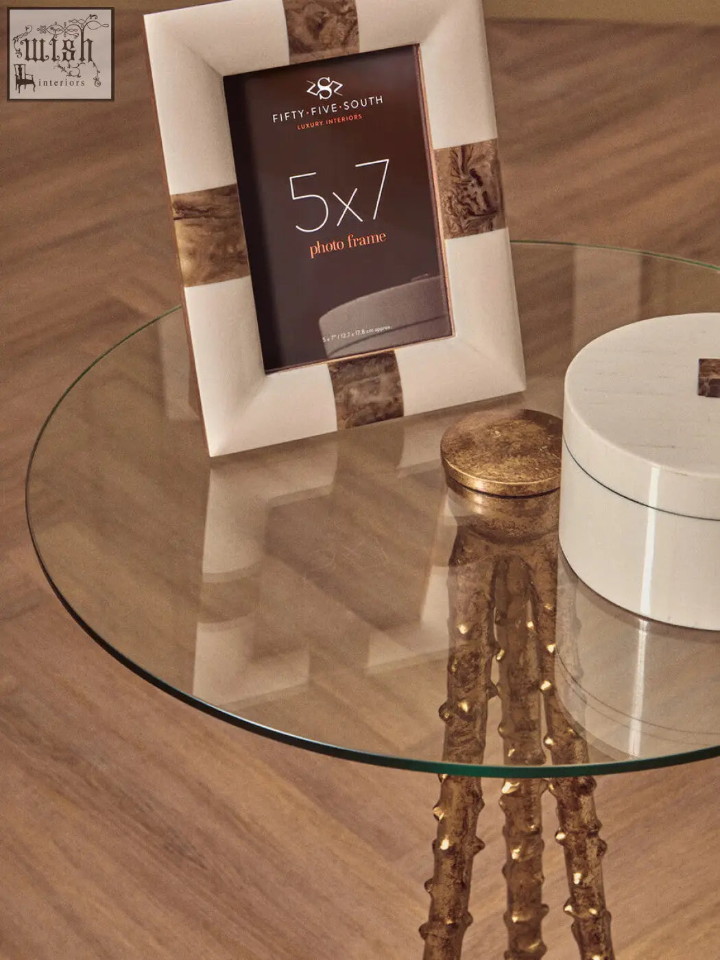 A white and gold marble patterned 5x7 photo frame with a warm gold triple-leg base for sika large side table