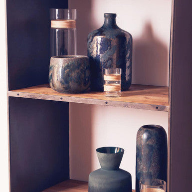 Dark textured ceramic silas brown planter with metallic accents on rustic wooden shelves brown planter