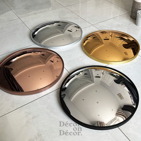 Silver bubble interactive mirror with circular convex silver mirror and black frame design in chrome and rose gold accents