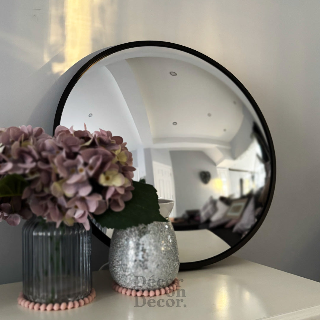 Silver bubble interactive mirror with a sleek black frame and reflective silver mirror surface