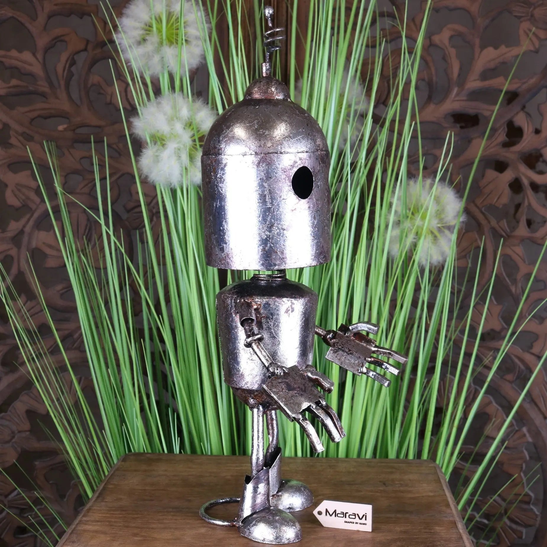 Silver robot ornament with metallic finish, rounded head, articulated limbs, and claw-like hands springy bobble head