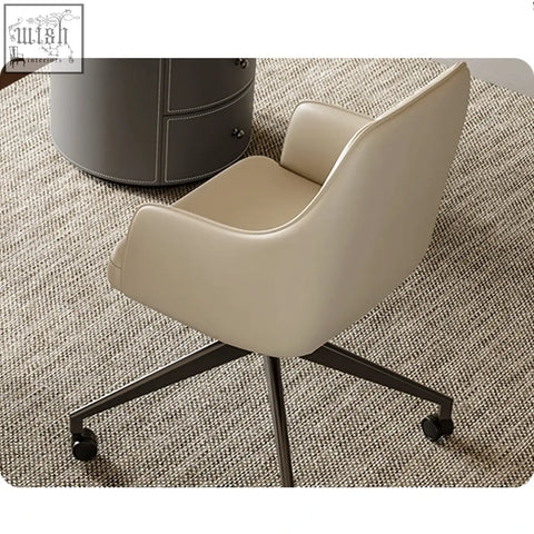 Cream-colored leather office chair with black metal base and wheels paired with solid wood simao office desk with storage drawers