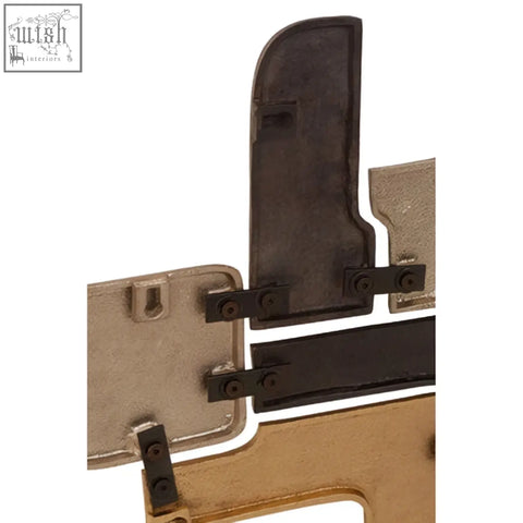 Black and gold metal wall sculpture with black plastic grips featuring simboLo metal wall design details
