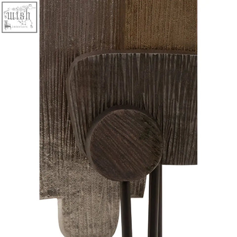 Dark brown textured wooden wall art with rustic handcrafted design alongside simbolo small assorted metal sculpture on marble base
