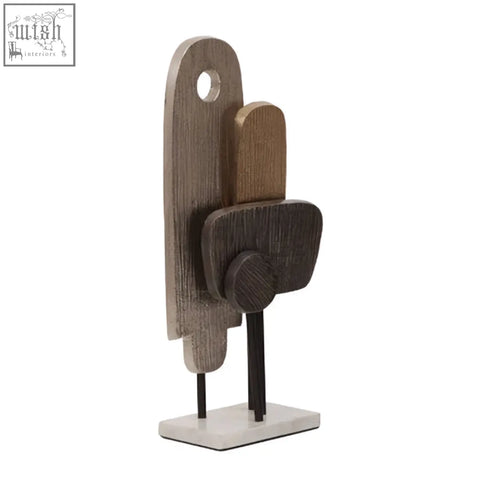 Stacked wooden cutlery holders with rustic finish and darkened accents paired with simbolo small assorted metal sculpture on marble base
