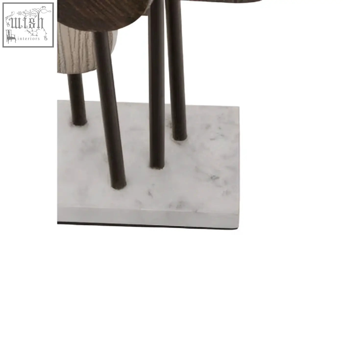 Dark metal legs support a simbolo small assorted colour metal sculpture with textured elements on a white marble base