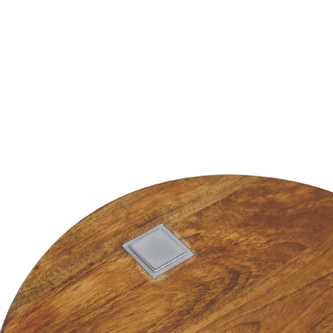A single chestnut bedside table with a round wooden top and a square brushed silver metallic inlay detail