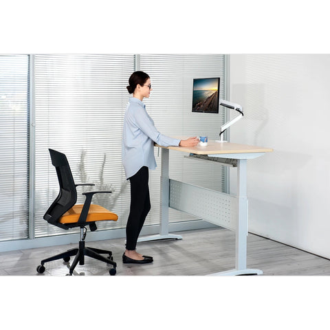 White adjustable standing desk with light wood top and perforated side panels paired with single gas spring monitor arm