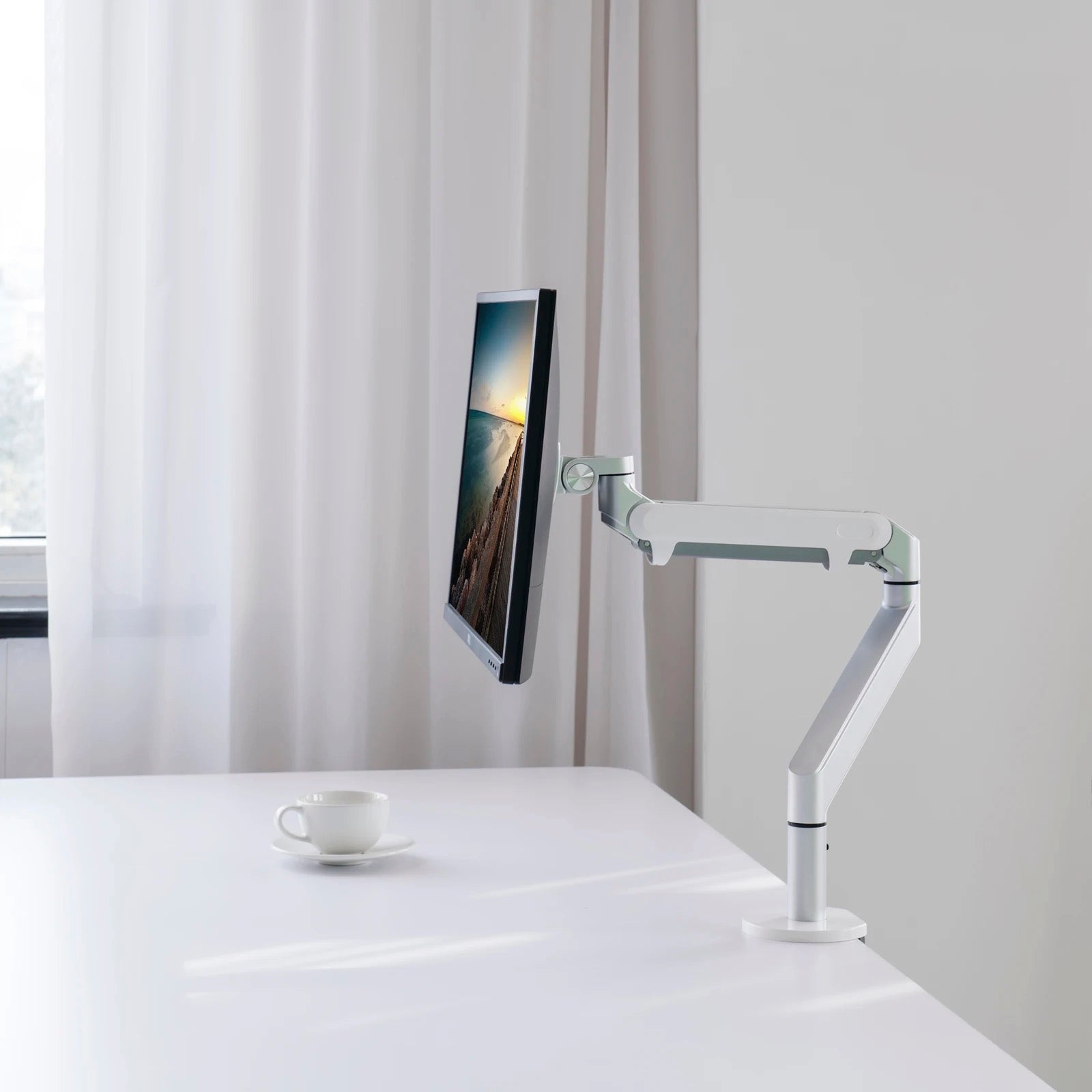 White single gas spring monitor arm holding a sleek modern display perfect for dual monitor setups