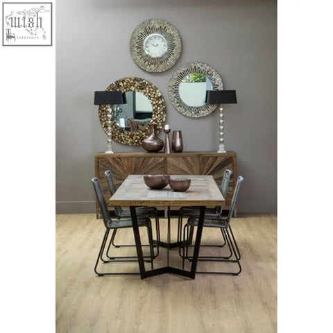 Rustic wooden dining table with light natural finish and black iron legs shown with sisal grey rope chair
