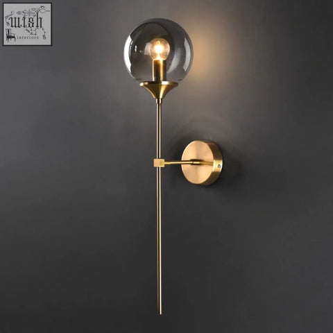 Gold-toned sizzle glass wall light with spherical glass globe and exposed bulb for warm ambient lighting