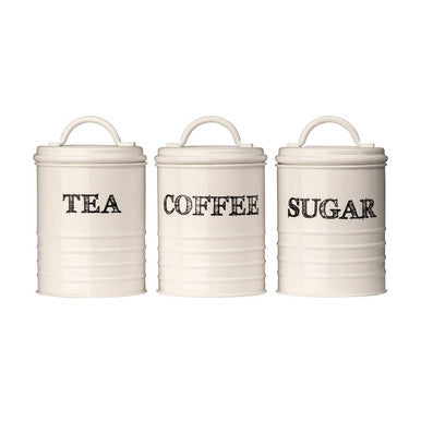 Cream-colored metal sketch tea coffee and sugar canister set with black lettering for kitchen storage