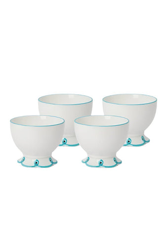 Set of four white ceramic egg cups with sky blue trim and eye-like motifs perfect for nibbles and snacks