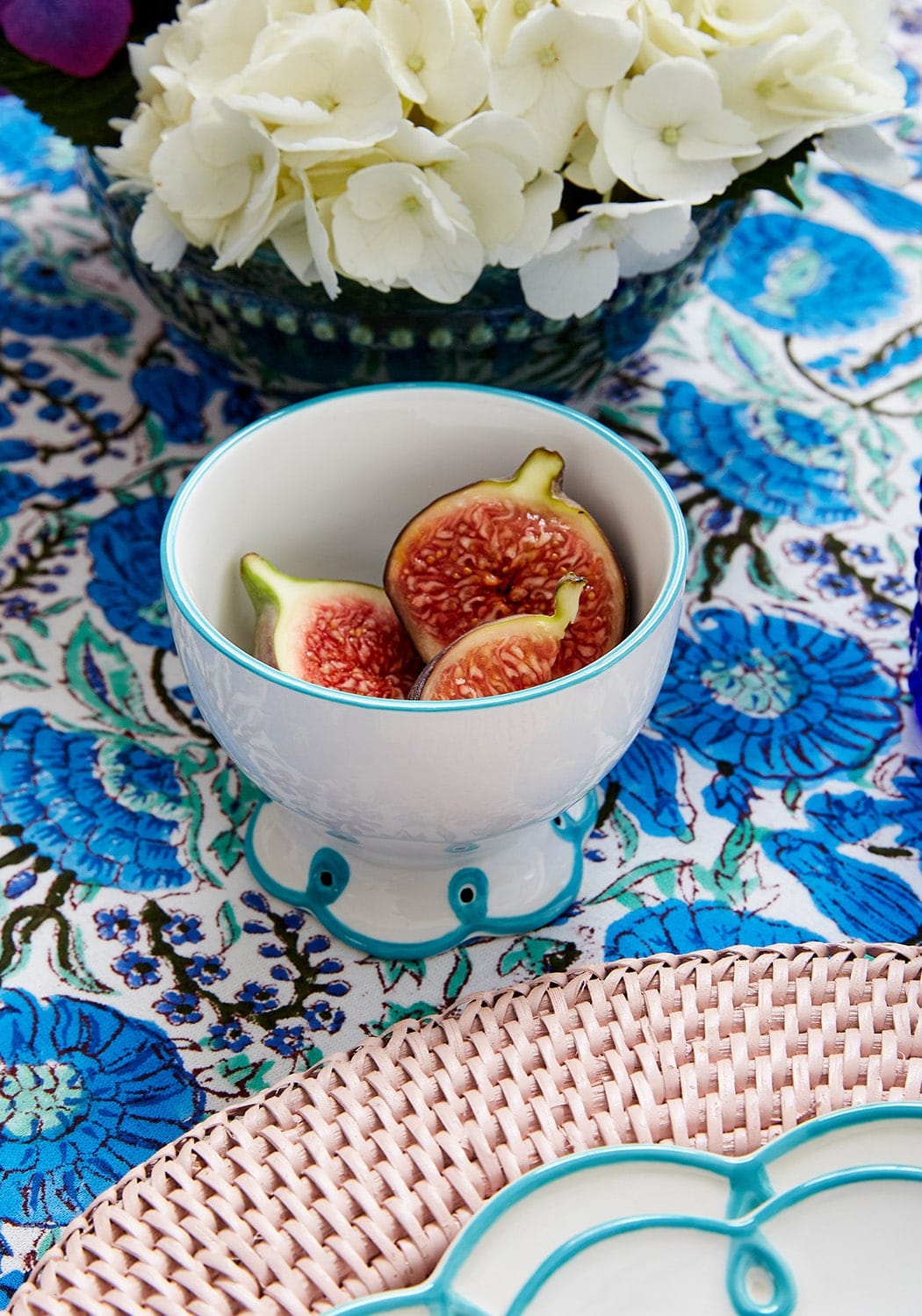 White ceramic nibbles bowl with sky blue scalloped rim and foot holding sliced figs set of 4