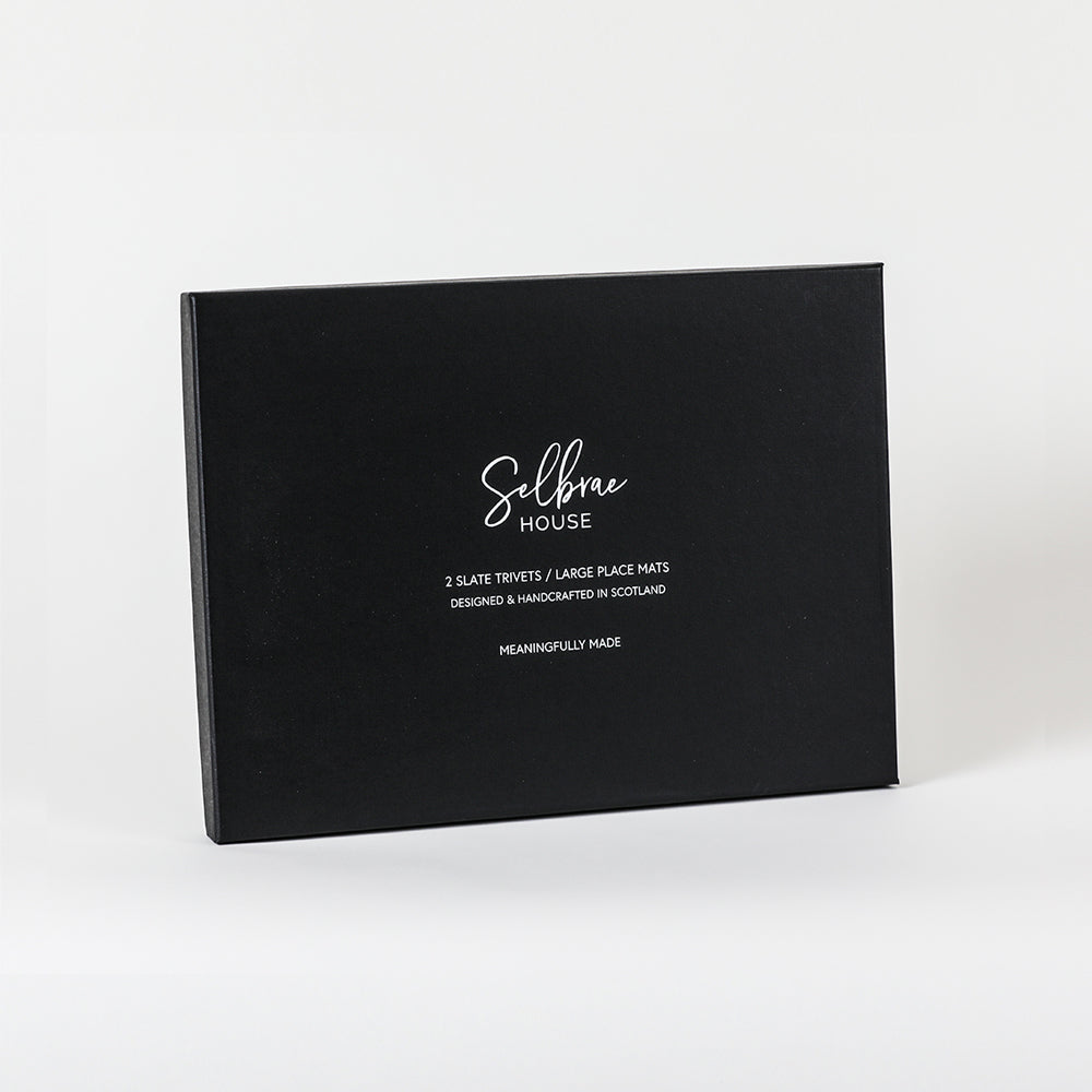 Black rectangular box with selbrae house branding containing slate large place mats set of 2 for dining use