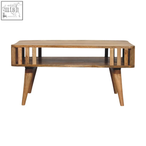 A rustic solid mango wood coffee table with vertical slats and angled legs in a warm oak-ish finish