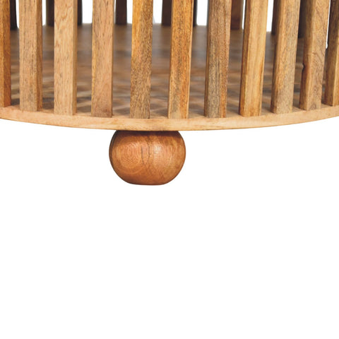 Light brown bun wooden foot with a polished finish on a slatted round oak-ish coffee table made of solid mango wood