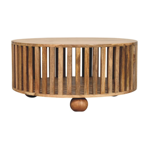 Slatted round oak-ish coffee table with vertical slats and a single bun wooden foot in solid mango wood