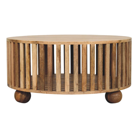 Slatted round oak-ish coffee table with solid mango wood vertical slats and bun wooden feet for living room use