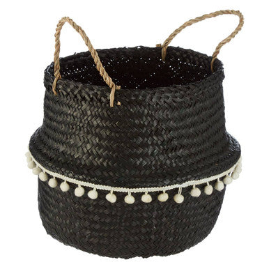 Small black seagrass basket with natural fiber handles and white pom-pom trim for stylish storage