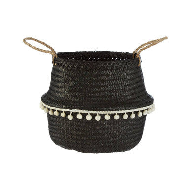 Small black seagrass basket with natural fiber handles and white pom-pom trim perfect for stylish storage