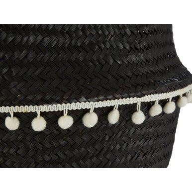 Small black seagrass basket with a black woven straw hatband decorated with fluffy white pom-poms