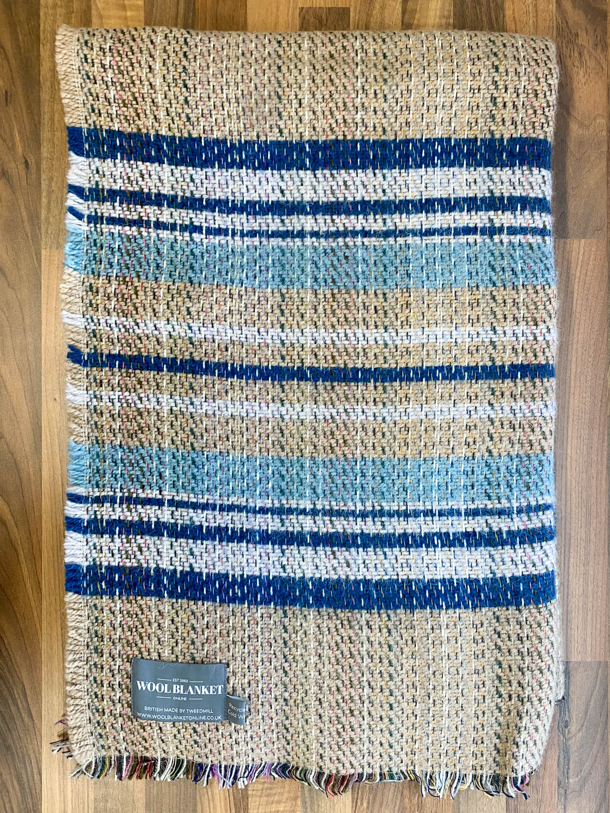Small checked random recycled wool blanket with cozy navy blue light blue and beige stripes and textured weave