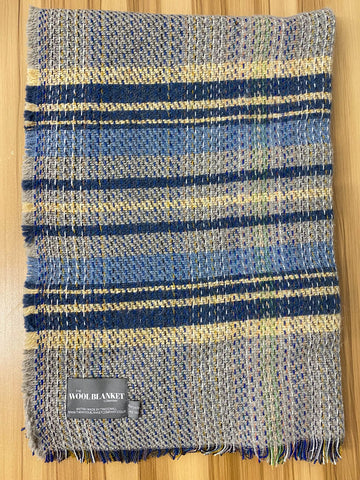 A cozy small checked random recycled wool blanket with navy blue beige and muted green stripes and soft fringed edge