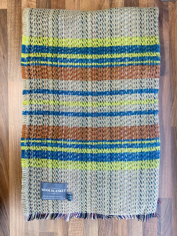 Small checked random recycled wool blanket with woven wool, horizontal stripes in green, blue, and brown on neutral base