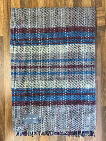 Small checked random recycled wool blanket with cozy handwoven plaid stripes in gray maroon and blue shades