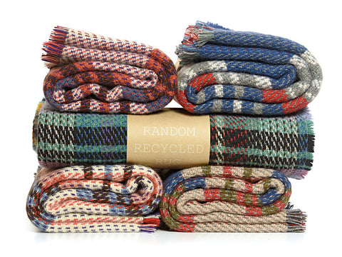 Stack of five small checked random recycled wool blankets in red beige blue gray and green black with fringed edges