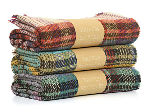 Stacked rolled-up small checked random recycled wool blankets with plaid earthy tones made from recycled wool materials