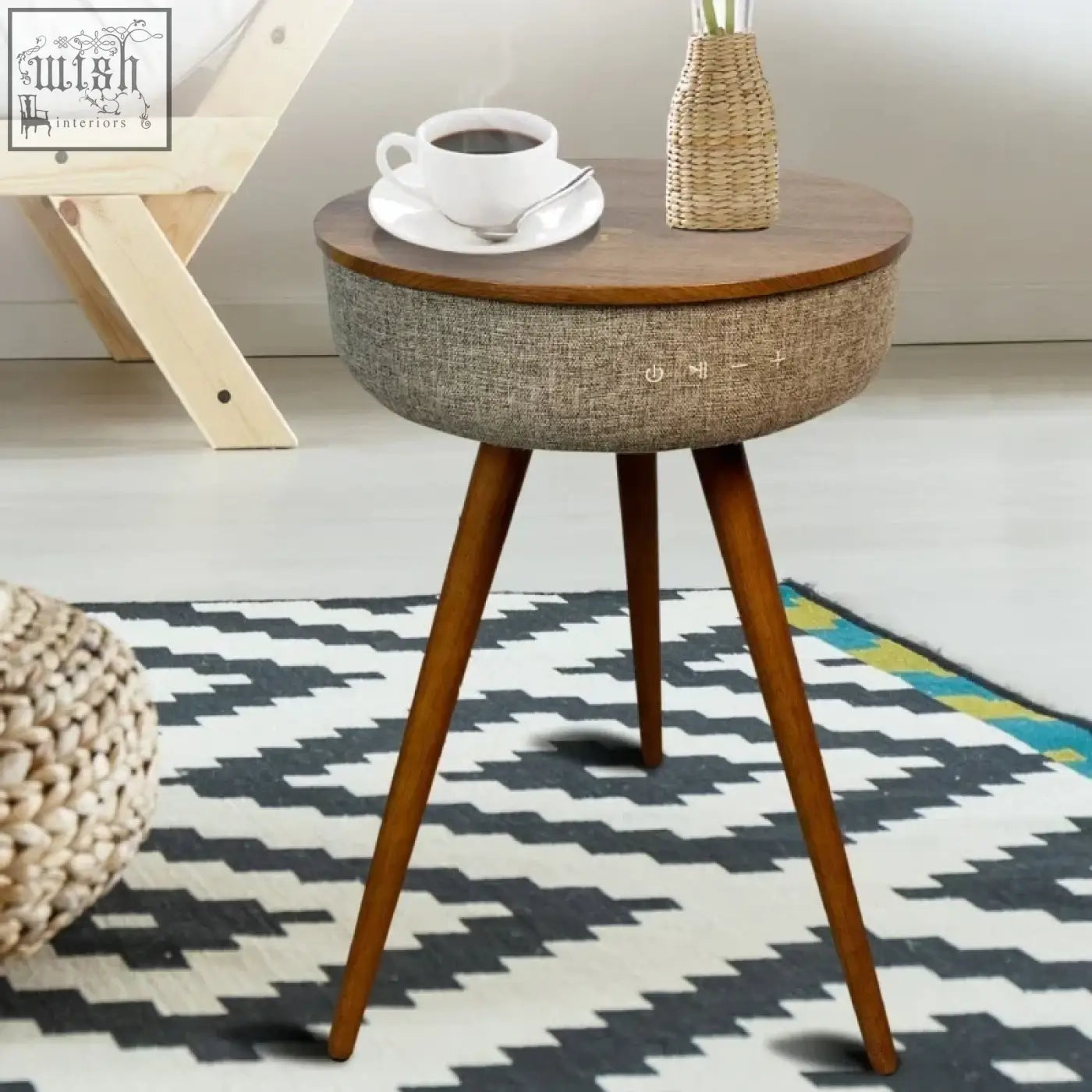 A round mid-century modern smart coffee table with a wooden top gray fabric body and built-in speakers