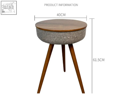 A sleek smart coffee table with a round wooden top and gray fabric body on tapered wood legs