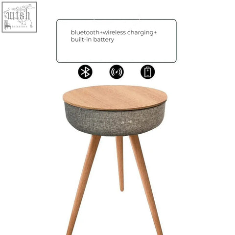 Sleek smart coffee table with light wood top gray fabric body and three wooden legs perfect for any modern space