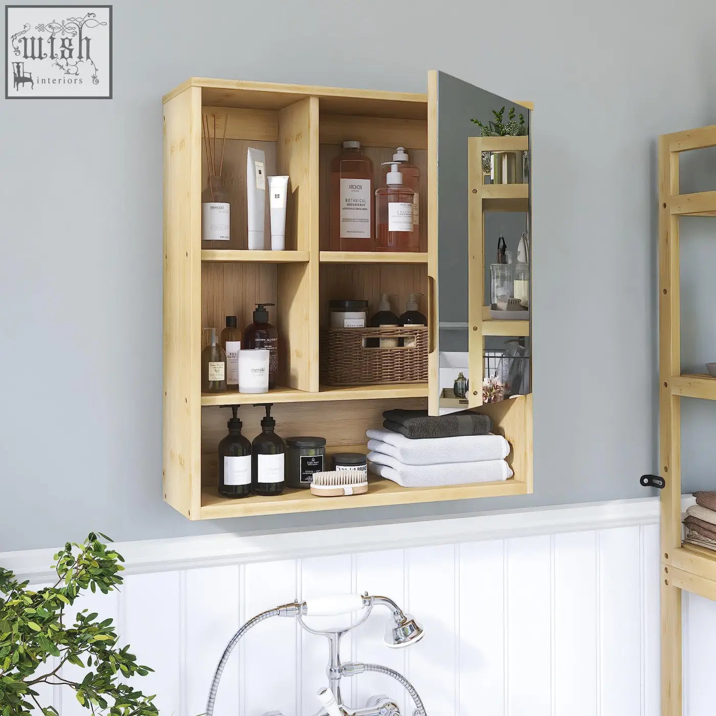 Light-colored bamboo wall-mounted medicine cabinet with mirrored door and multiple compartments for storage space