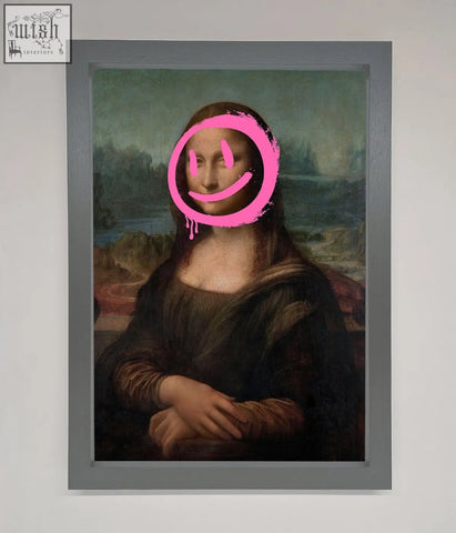 A smiley mona lisa framed print featuring a bright pink smiley face painted over the classic artwork in a sleek frame