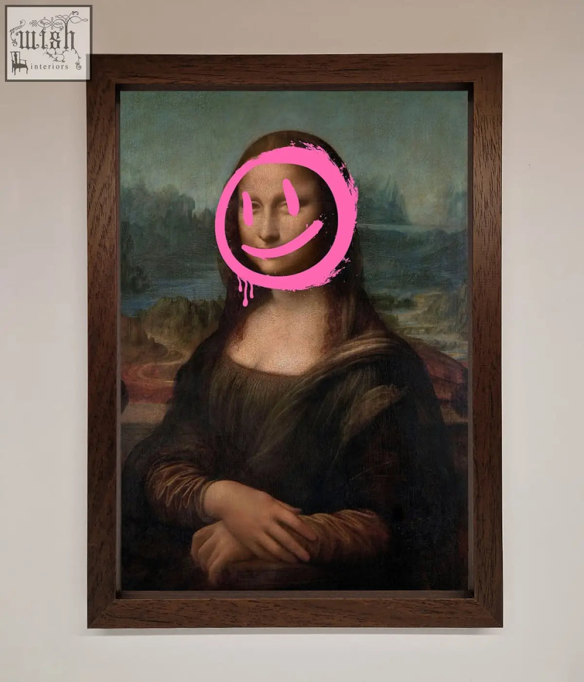 A smiley mona lisa framed print featuring a classic mona lisa painting with a bright pink smiley face sticker cover