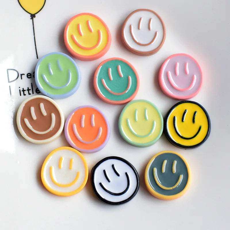 Colorful glossy smiling glow fridge magnet pack with pastel and vibrant smiley face buttons and contrasting outlines
