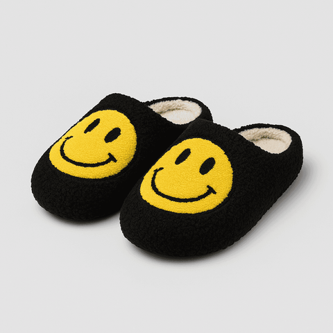 Black fuzzy slip-on smiling slippers with bright yellow smiley face design made of soft faux fur for cozy wear