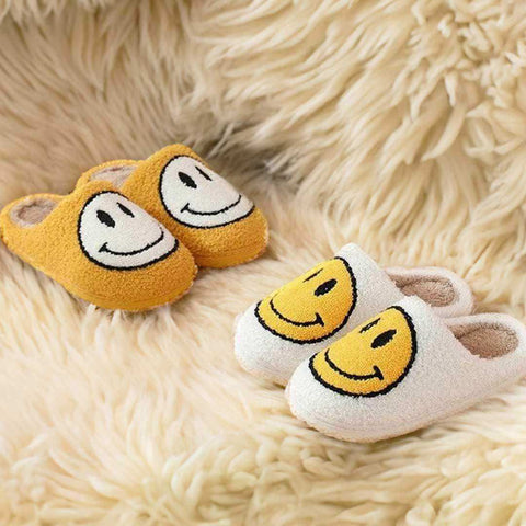 Yellow and white faux fur smiling slippers with embroidered smiley faces for cozy indoor wear