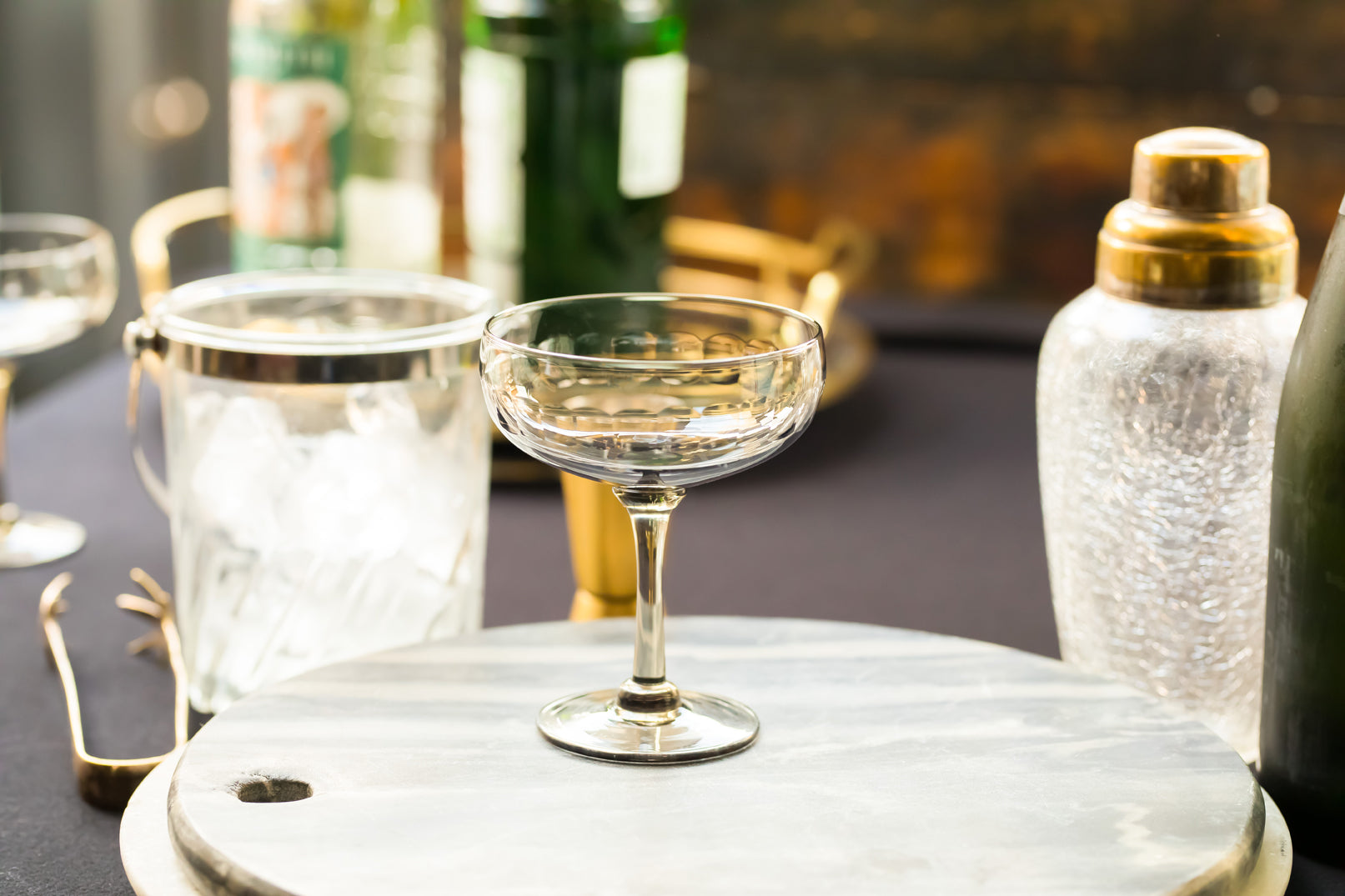 four smoky crystal cocktail glasses with lens design
