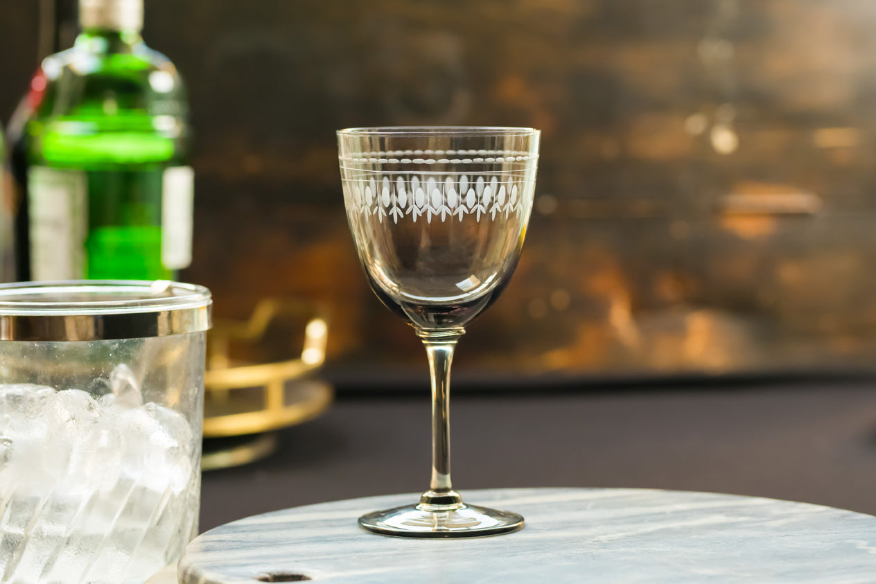 four smoky crystal wine glasses with ovals design
