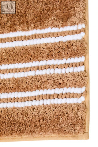 Tan soak large camel bath mat with plush textured surface and white horizontal stripes for cozy bathroom use