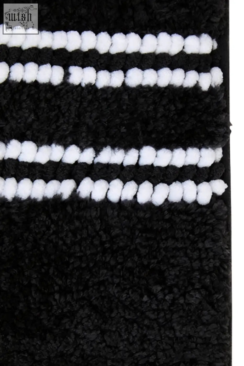 Large charcoal grey plush bath mat with soft white pom-pom trim for cozy bathroom use