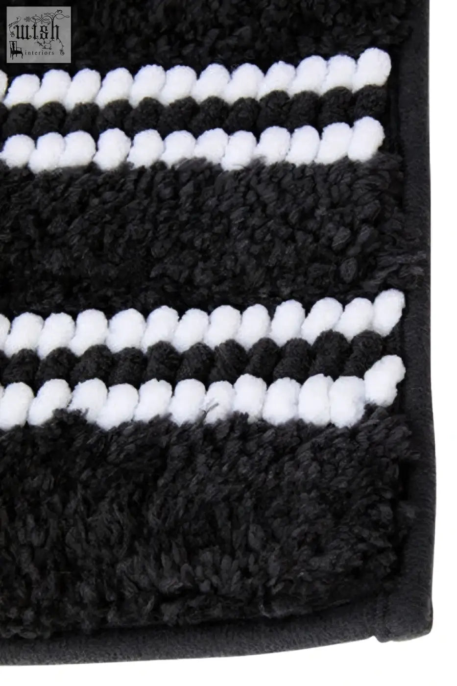 Large charcoal grey bath mat with plush textured surface and black and white stripes for bathroom use