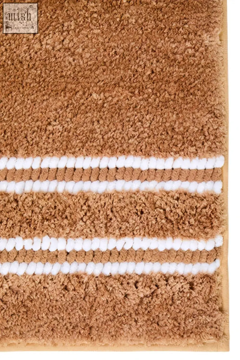 Tan plush small camel bath mat with three white woven stripes perfect for cozy bathroom floors
