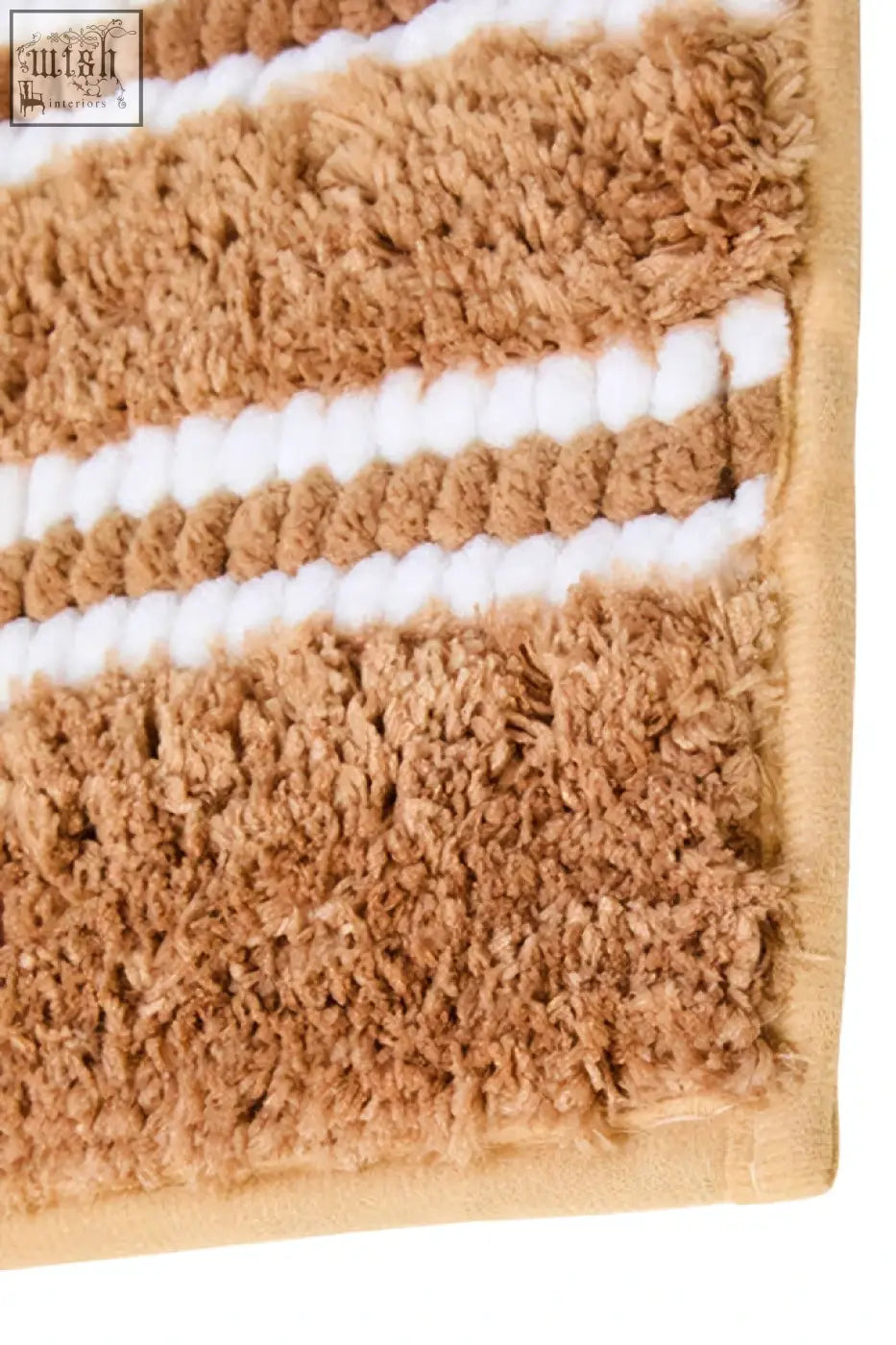 Tan and white striped plush small camel bath mat with soft textured surface for a cozy bathroom feel
