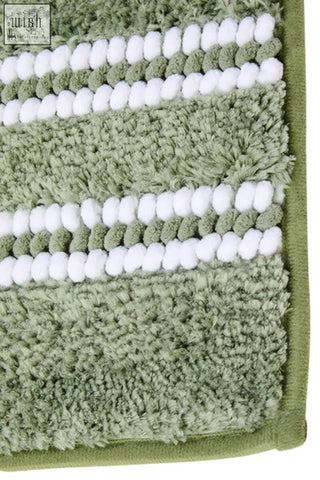 A plush sage green bath mat with soft terry cloth and white braided stripes perfect for a green bath space